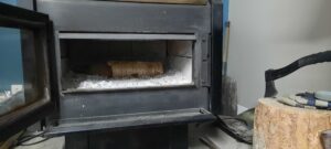 picture of a log inside a wood burning stove showing a visual explanation of the text